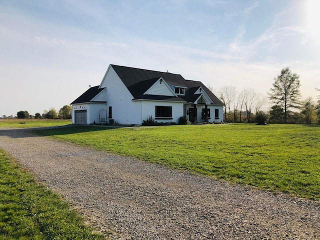 view of front of house with a garage and a front yard