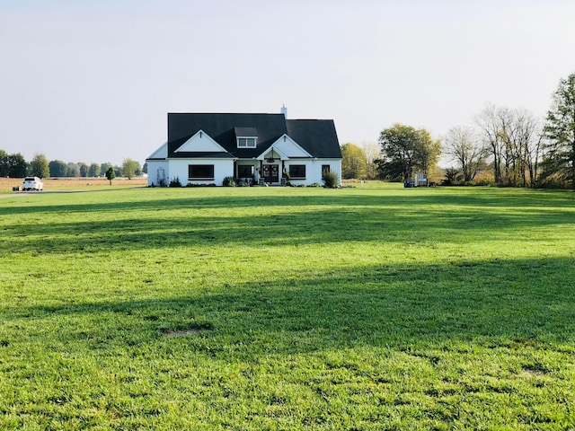 new england style home featuring a front lawn