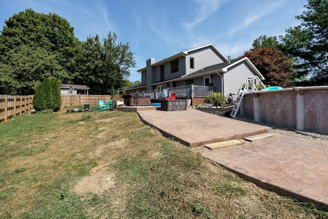 3630 Singing Wind Way, Urbana, OH 43078 - rear view of property with a fenced backyard, a deck, a chimney, and a patio