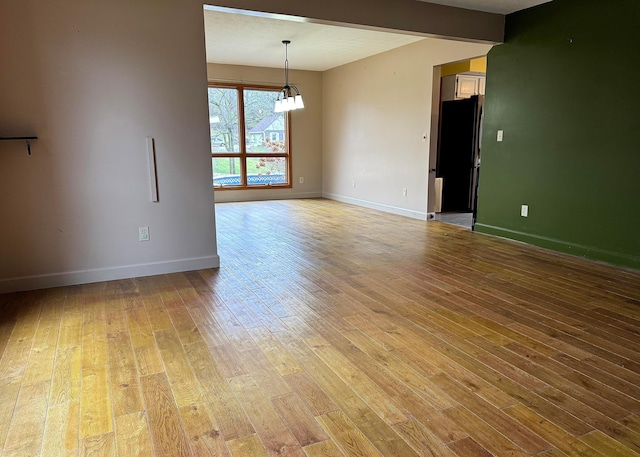 3630 Singing Wind Way, Urbana, OH 43078 - empty room with light wood finished floors and a chandelier