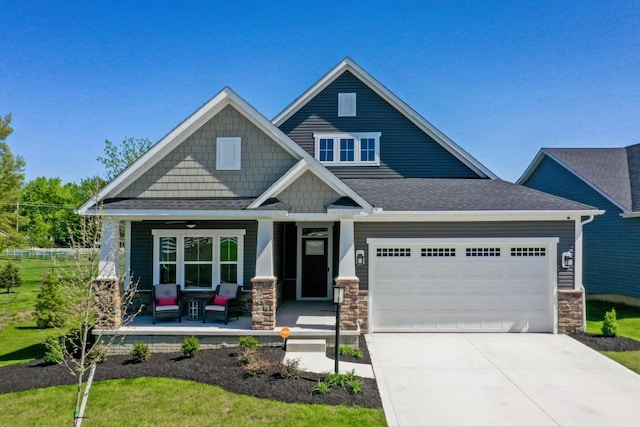 craftsman-style home with a porch and a garage