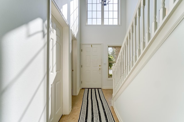 tiled entryway with a high ceiling