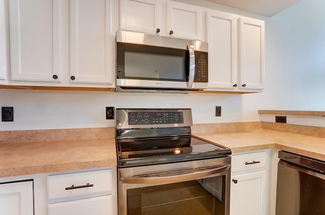 kitchen featuring white cabinetry and appliances with stainless steel finishes