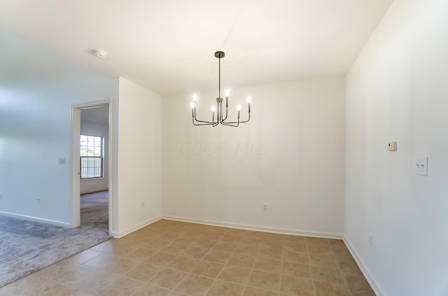 unfurnished room featuring light tile patterned floors and an inviting chandelier