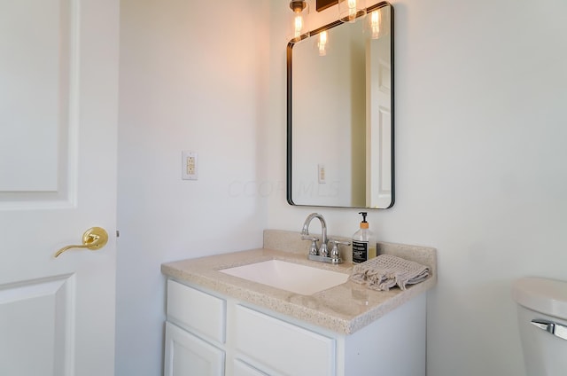 bathroom featuring toilet and vanity