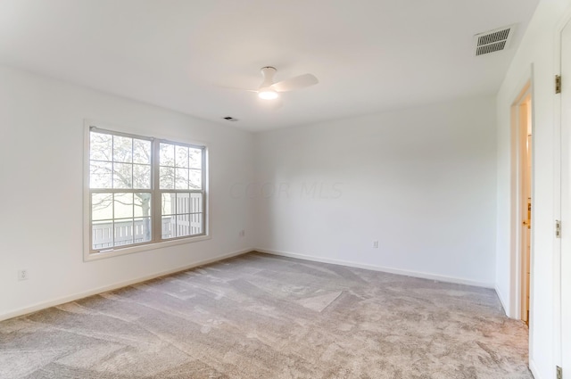 carpeted empty room featuring ceiling fan