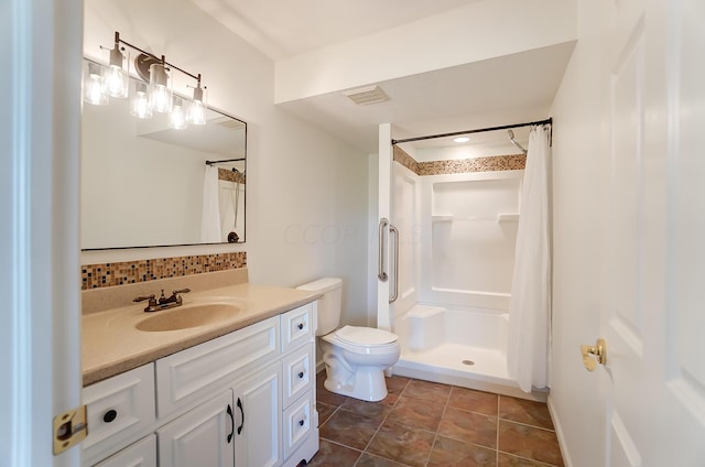 bathroom with backsplash, toilet, walk in shower, and vanity