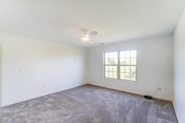 carpeted empty room featuring ceiling fan