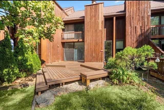 back of property featuring a wooden deck