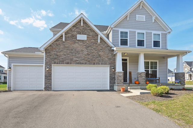 view of front of home with a porch and a garage