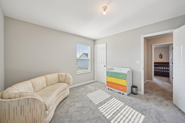 sitting room with carpet and baseboards