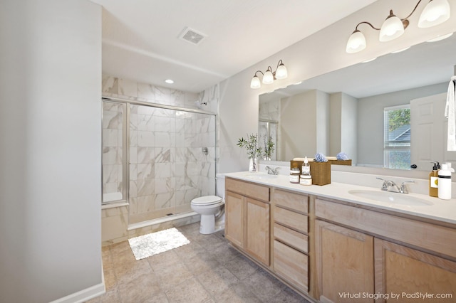 full bath featuring double vanity, a stall shower, visible vents, and a sink