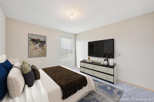 bedroom featuring carpet and baseboards