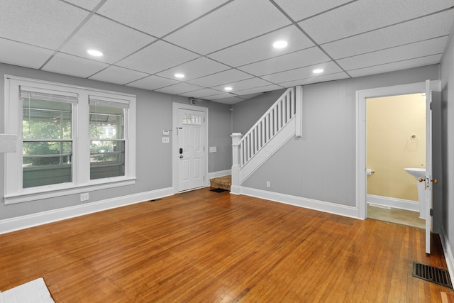 entryway with a paneled ceiling and wood-type flooring