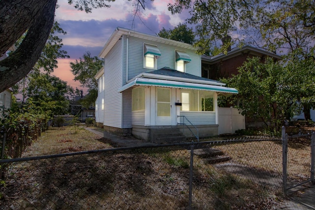 view of front of house featuring a fenced front yard and entry steps