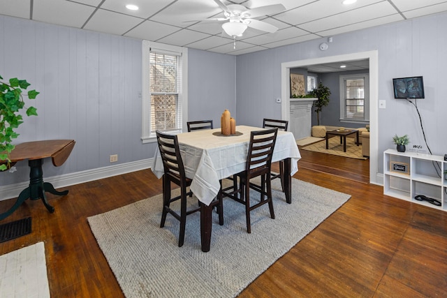 dining space featuring a paneled ceiling, wood finished floors, and visible vents