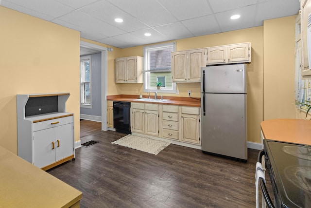 kitchen with a sink, black dishwasher, electric stove, freestanding refrigerator, and dark wood-style floors