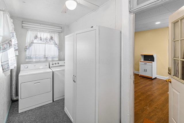 clothes washing area featuring laundry area, dark wood-style flooring, a ceiling fan, baseboards, and washer and dryer