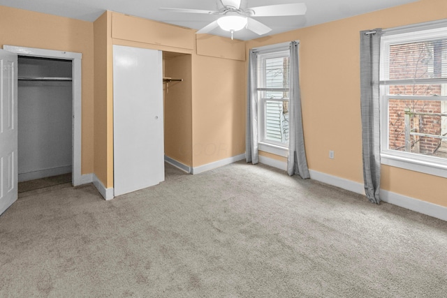 unfurnished bedroom featuring light colored carpet, ceiling fan, and baseboards