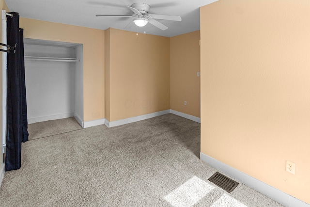 unfurnished bedroom with baseboards, a closet, visible vents, and carpet flooring