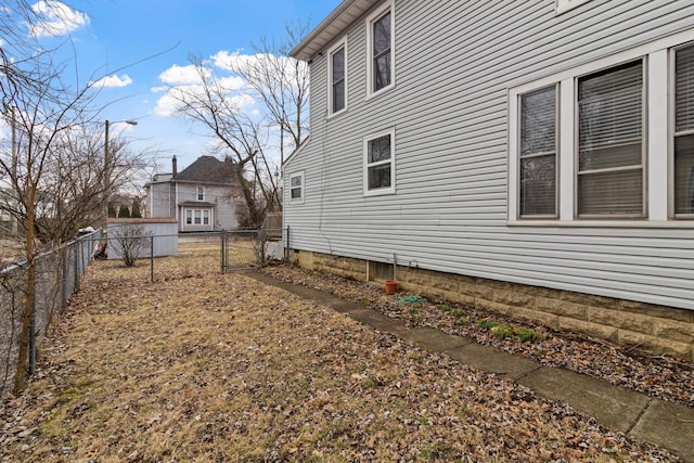 view of home's exterior featuring a gate and fence