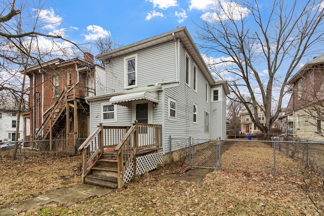 view of front of property with a fenced backyard and a gate