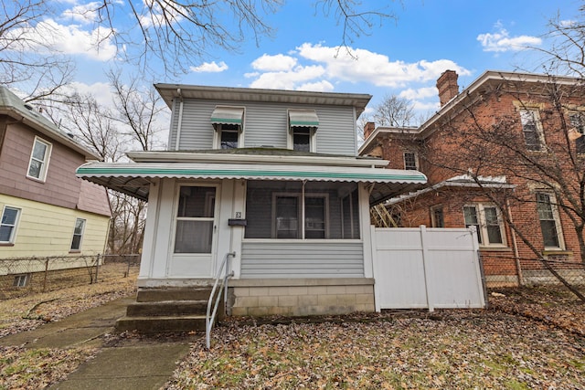 view of front of house featuring entry steps and fence