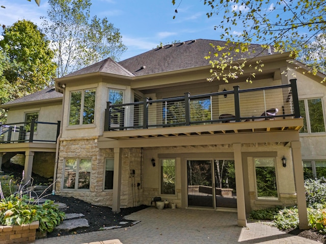 back of property with a balcony and a patio area