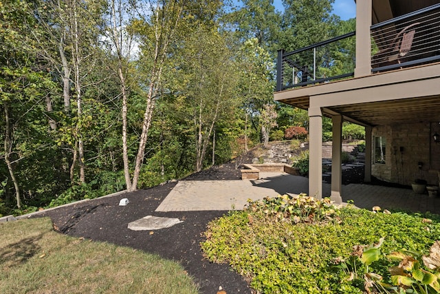 view of yard featuring a patio area and a balcony