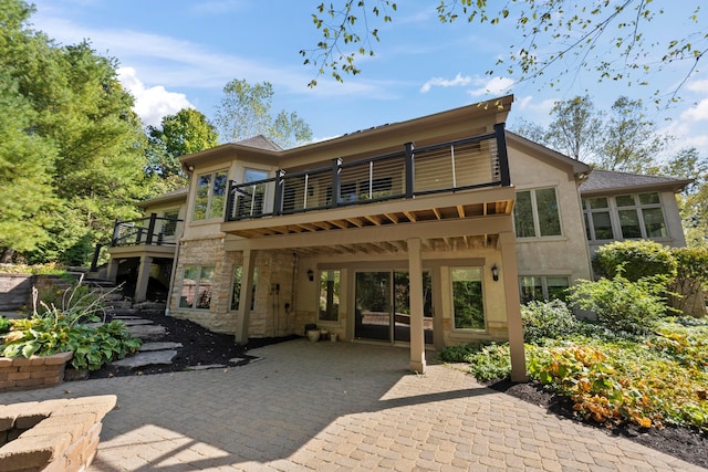 back of house with a balcony and a patio area