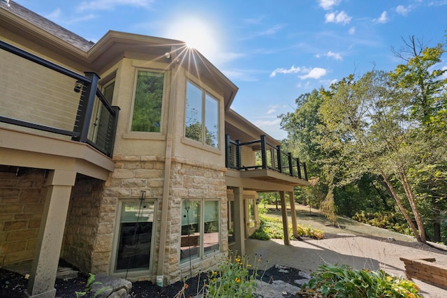 view of side of property featuring a balcony