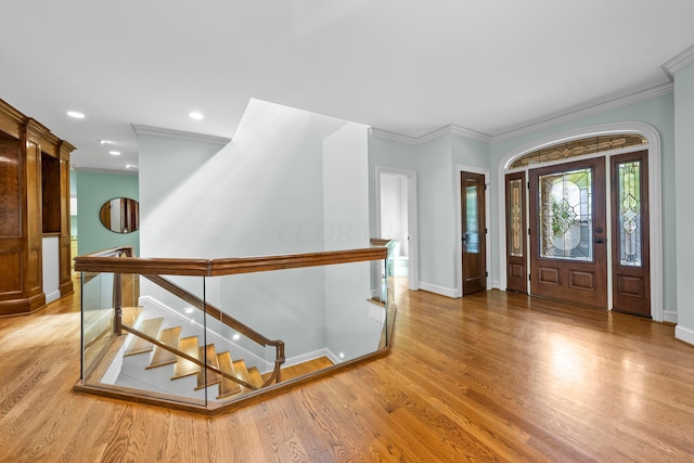 entryway featuring hardwood / wood-style flooring and ornamental molding