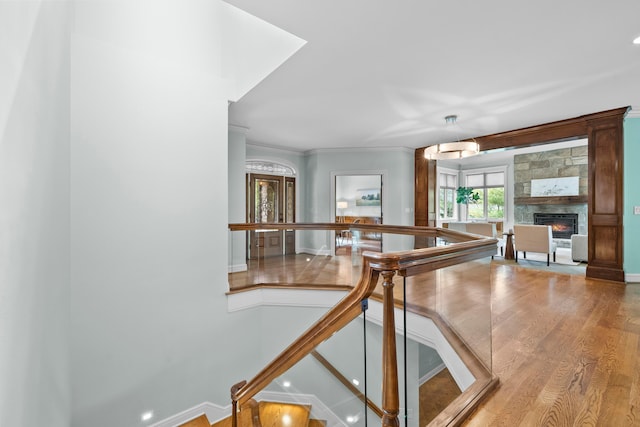 interior space featuring crown molding, a fireplace, and hardwood / wood-style flooring