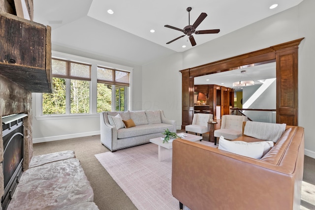 carpeted living room with vaulted ceiling and ceiling fan