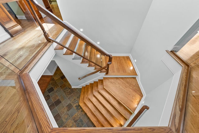 staircase with wood-type flooring