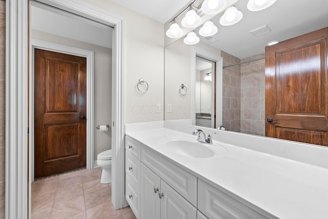 bathroom with tile patterned flooring, vanity, and toilet