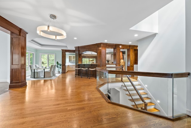 hallway featuring light wood-type flooring and crown molding