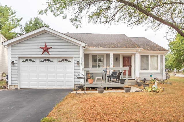 single story home with covered porch and a garage