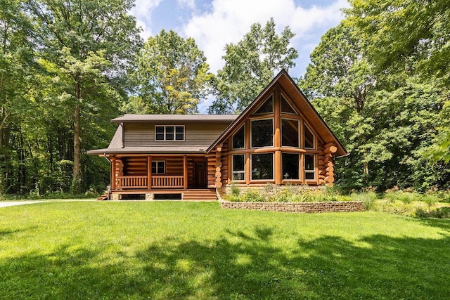 rear view of house featuring a lawn and a porch