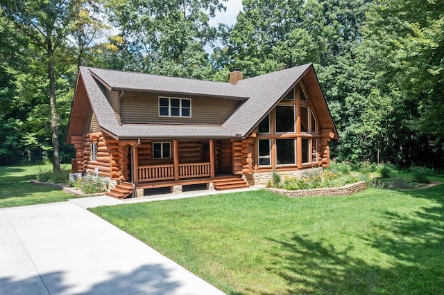 log-style house with covered porch and a front lawn