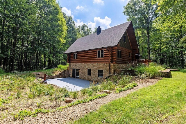 view of property exterior with a patio area