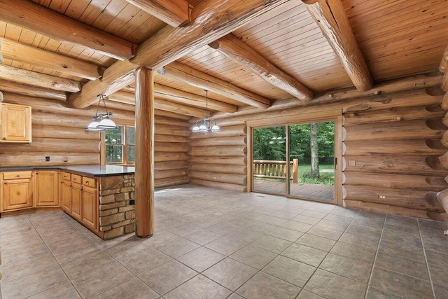 kitchen featuring beamed ceiling, rustic walls, hanging light fixtures, and wood ceiling