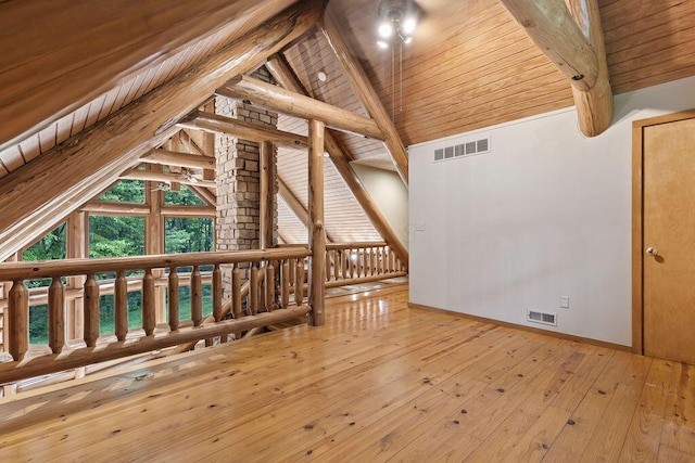 additional living space featuring vaulted ceiling with beams, wood ceiling, and light hardwood / wood-style flooring