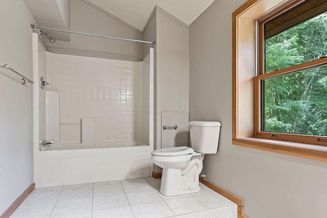 bathroom with tile patterned floors, plenty of natural light, toilet, and lofted ceiling