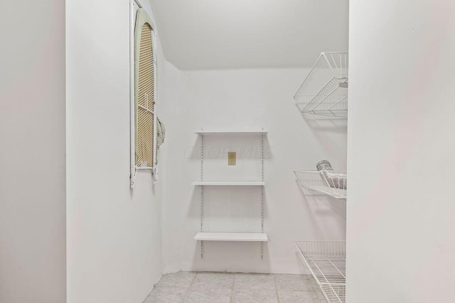 spacious closet featuring light tile patterned floors