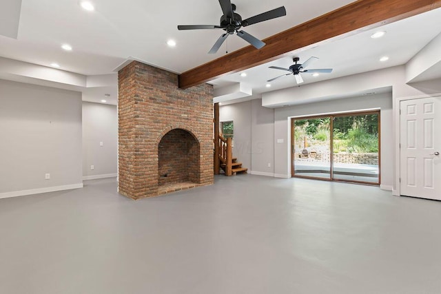 unfurnished living room with concrete flooring, beam ceiling, ceiling fan, and a fireplace