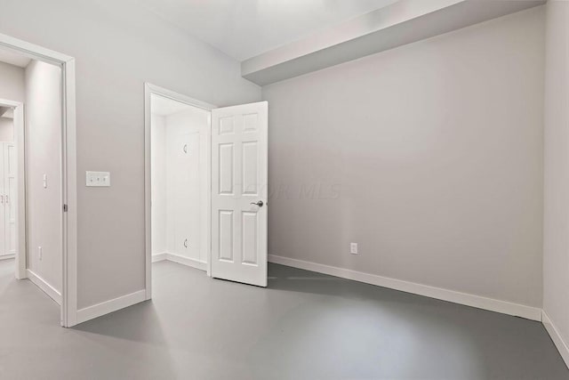 unfurnished bedroom with concrete floors