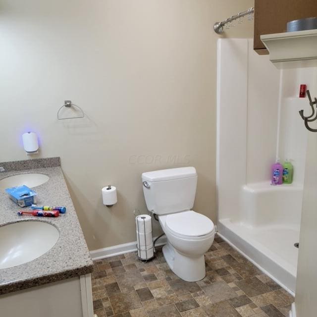 bathroom with vanity, toilet, and walk in shower