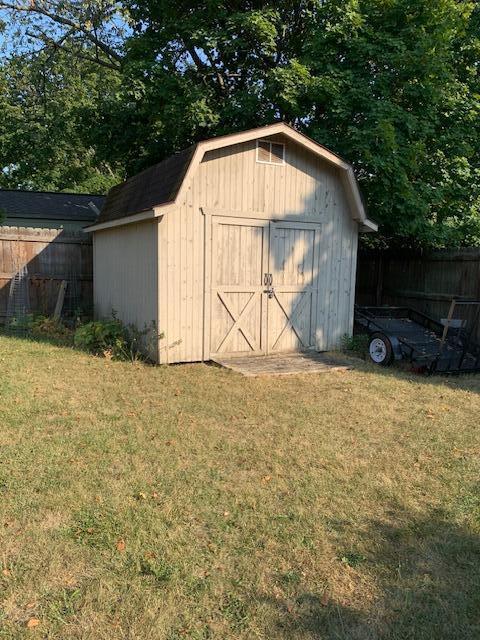 view of outbuilding with a yard