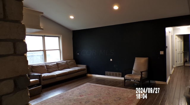 living room with wood-type flooring and vaulted ceiling